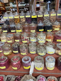 Rows of glass jars containing colorful candies and sweets on market shelves