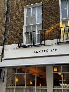 Exterior facade of Café Nac with signage and windows