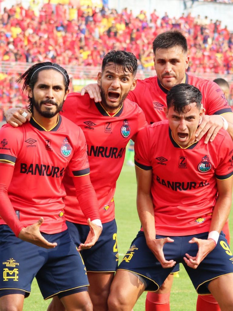 Soccer team celebrating championship win with trophy on the field