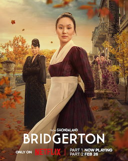 Woman in burgundy Regency dress standing before autumn foliage with other characters in background
