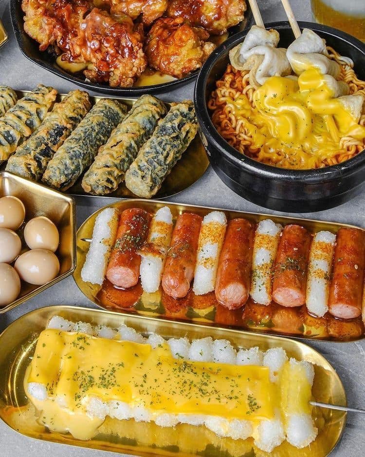 Korean food spread with rice, kimchi and assorted side dishes on a table