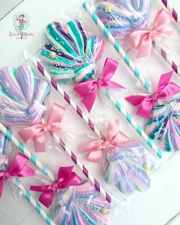 Colorful swirl lollipops with pink bows and striped sticks on white background