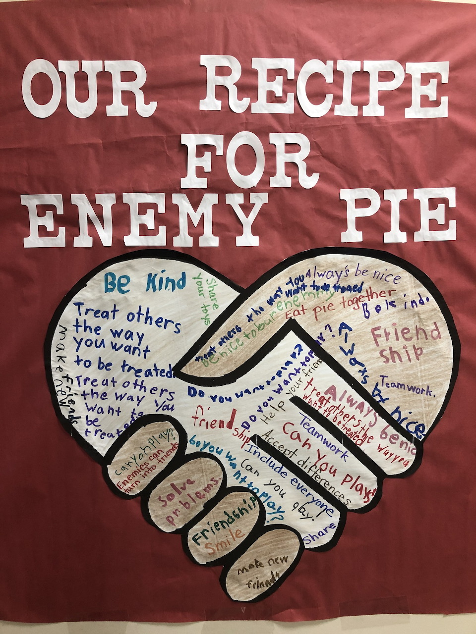 Classroom poster 'Our Recipe for Enemy Pie' with two hands forming a heart, filled with kindness and friendship messages