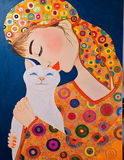 Woman with closed eyes in vibrant circular patterned dress holding white cat