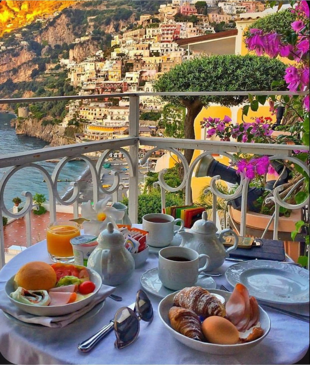 Pastel houses on Amalfi Coast cliffs above the Mediterranean Sea.
