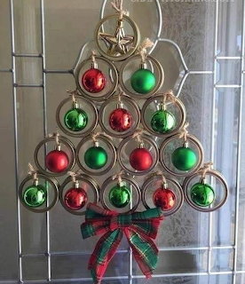 Christmas tree made of stacked horseshoes with red and green ball ornaments and plaid ribbon bow