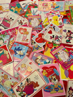 Collection of vintage Valentine's Day cards with retro cartoon illustrations spread across a surface