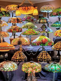 Colorful stained glass lampshades and Tiffany-style lamps displayed indoors