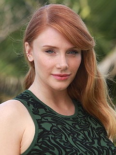 Portrait of woman with red hair in green dress outdoors