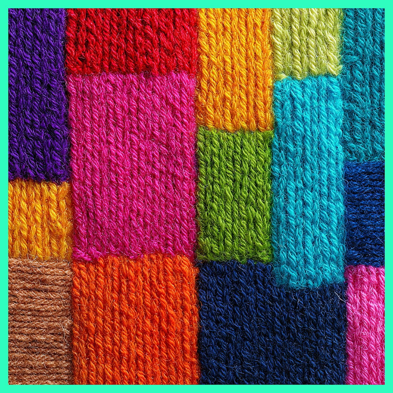 Colorful yarn skeins arranged in rectangular blocks showing texture of twisted wool fibers in bright colors
