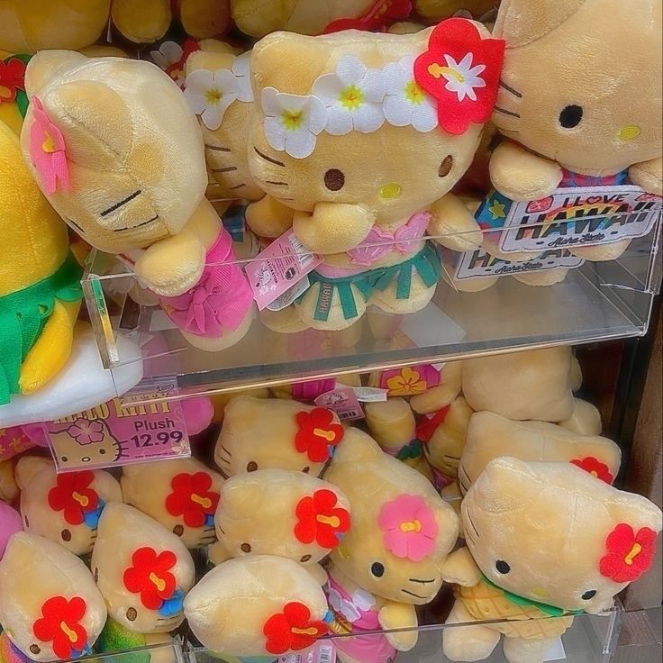 Hello Kitty plush toys in Hawaiian outfits and flowers piled in a store display bin