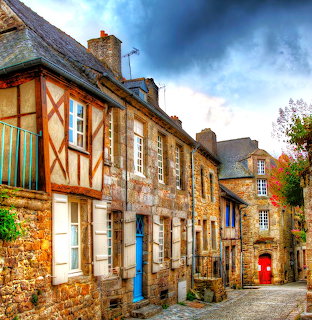 Traditional half-timbered houses along cobblestone street in historic French village