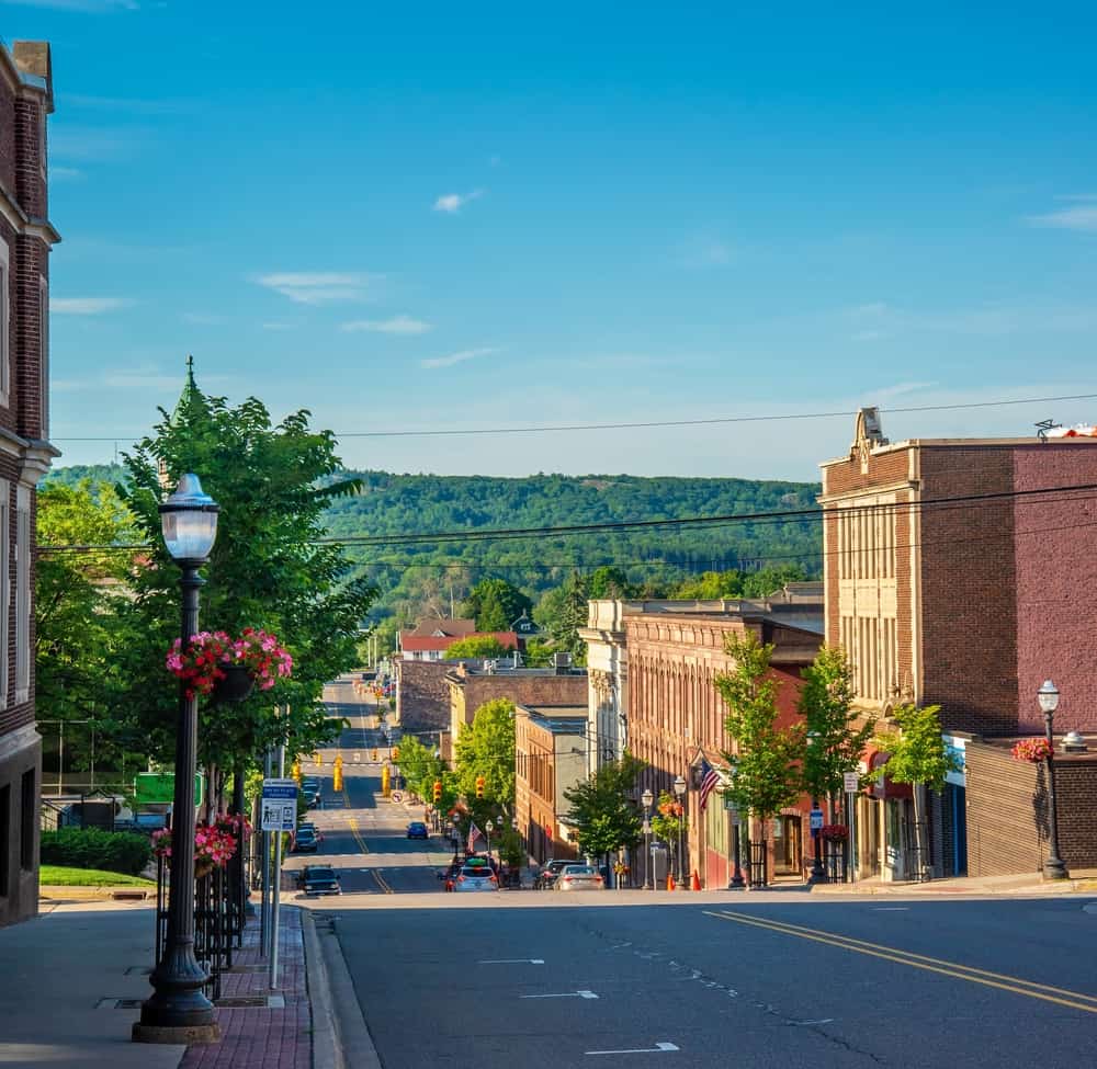 Downtown Marquette Michigan main street sloping toward Lake Superior with brick buildings and trees