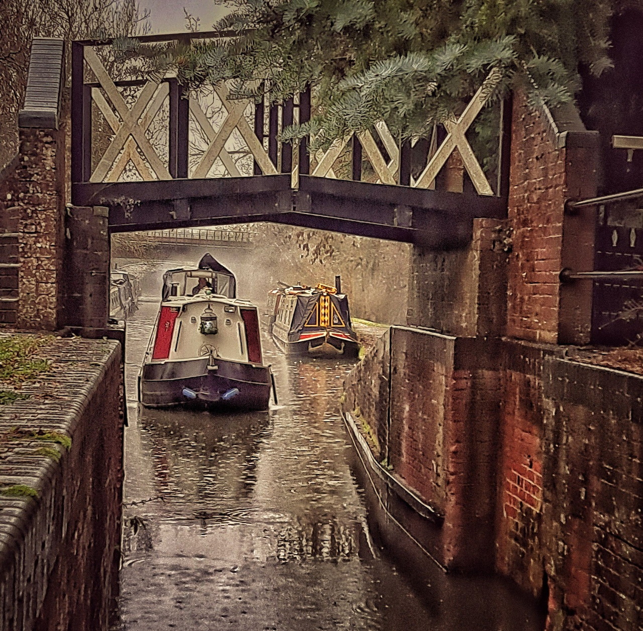 Two narrowboats traveling through a brick canal under a wooden bridge