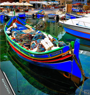 Brightly painted traditional Maltese fishing boats docked in calm harbor waters