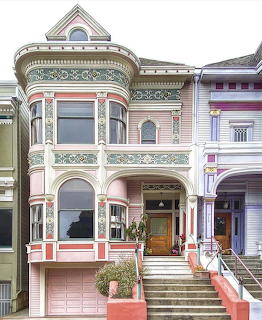 Ornate pink Victorian house with decorative trim and bay windows in San Francisco