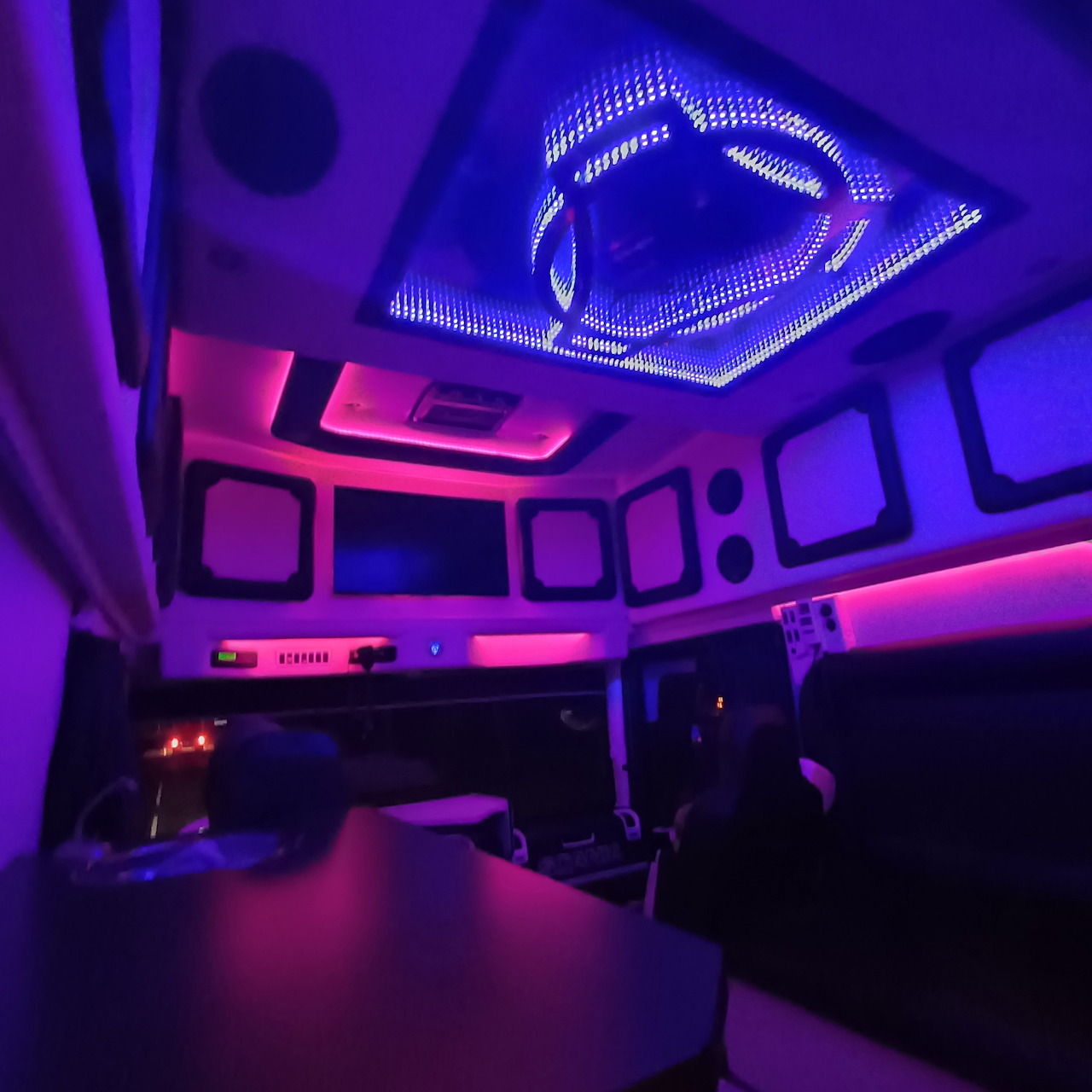 Truck cab interior with purple and blue LED lighting on the ceiling and dashboard