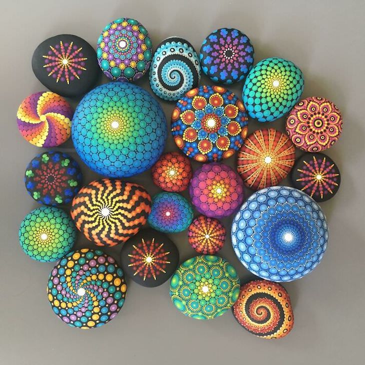 Colorful hand-painted pebbles with mandala and geometric dot patterns arranged in a group
