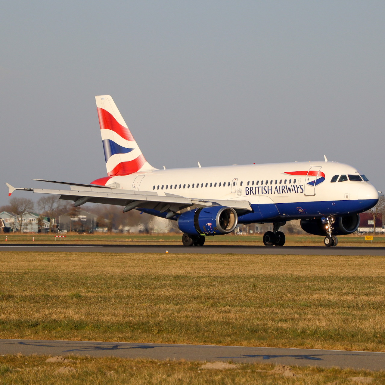 British Airways Airbus A319 on airport runway with Union Jack tail design