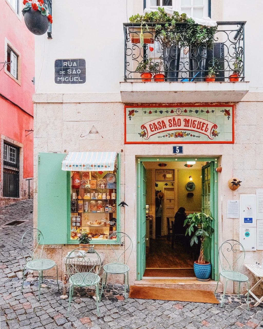 Charming Lisbon storefront with pastel buildings and cobblestone street in Portugal