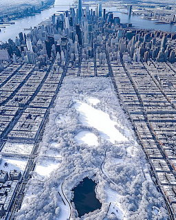 Aerial view of snowy New York City with Manhattan skyline and frozen surroundings