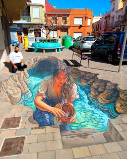 3D pavement art of mermaid with child in illusory water pool on village street