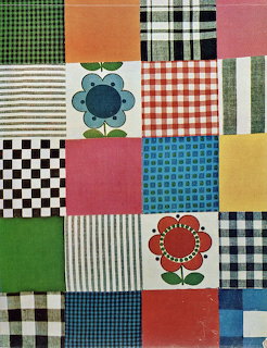 Vintage patchwork quilt sampler with checkered, striped and floral fabric squares and retro flower appliqués
