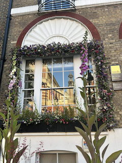 Flower-framed window on a brick building in London