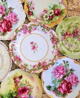 Overhead view of vintage floral china plates with pink roses and gold trim arranged in overlapping pattern