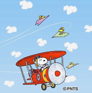 Snoopy in red biplane with Woodstock and birds on paper airplanes in cloudy sky