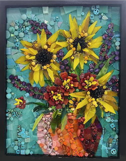 Mosaic art of sunflowers and red flowers in an orange vase on turquoise background