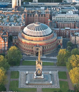 Aerial photograph of Royal Albert Hall showing circular domed building with memorial and cityscape