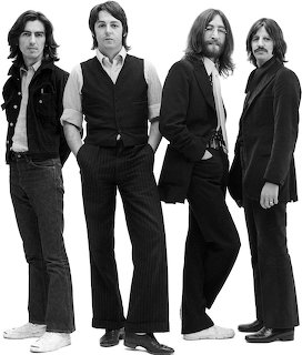 Black and white photo of four members of The Beatles standing in a row against white background