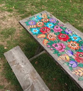 Painted picnic table in a colorful flower garden