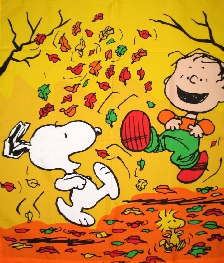 Snoopy dancing with Charlie Brown among falling autumn leaves on yellow and orange background