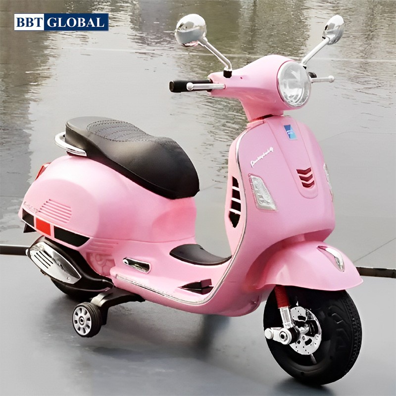 Pink battery-powered toy scooter with black seat and training wheels on gray surface