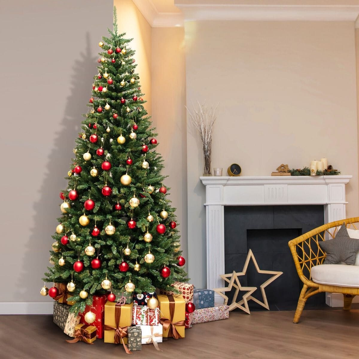 Decorated Christmas tree with ornaments and gifts beside white fireplace in living room