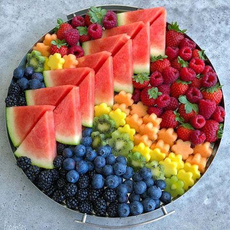 Assortment of fresh mixed fruit including apples, oranges, grapes and berries