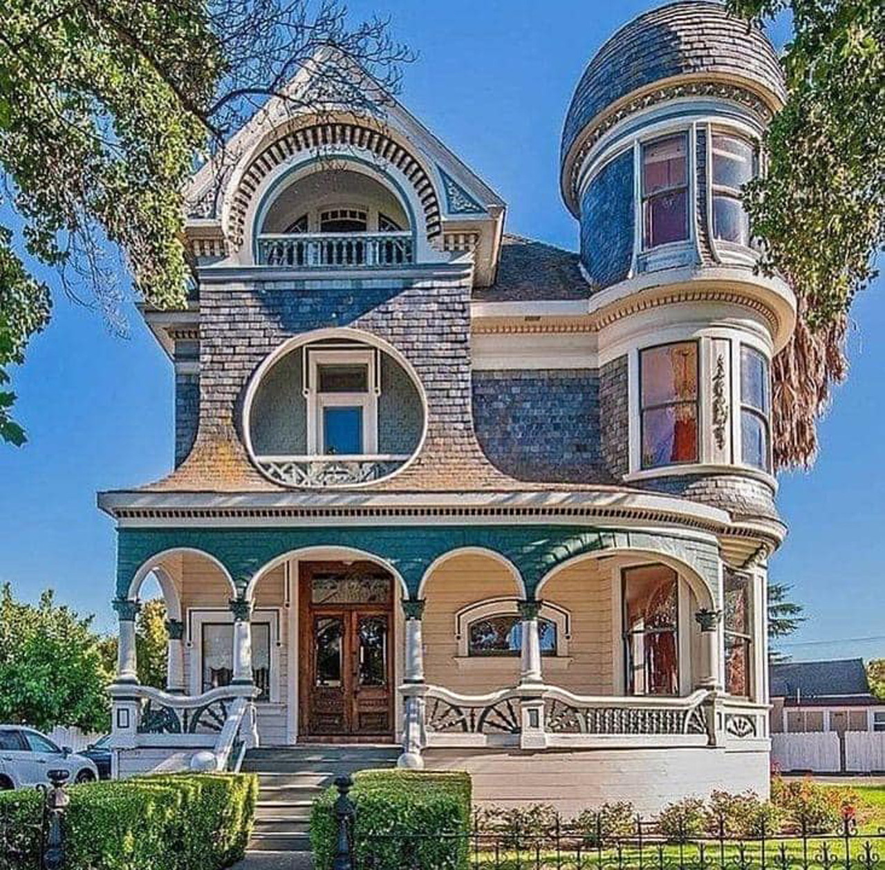 Victorian house with turret, porch, and decorative trim viewed from the front