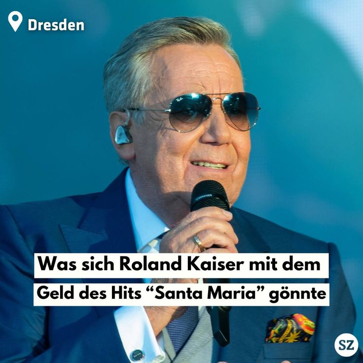 Roland Kaiser singing on stage with sunglasses and microphone, text overlay visible