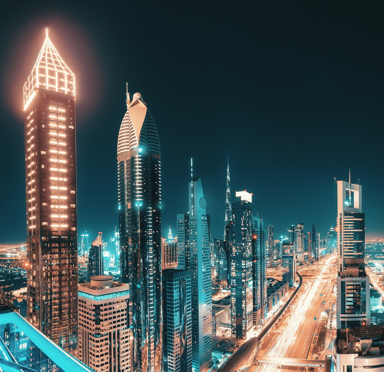 Night cityscape of Dubai skyscrapers along Sheikh Zayed Road with bright traffic lights