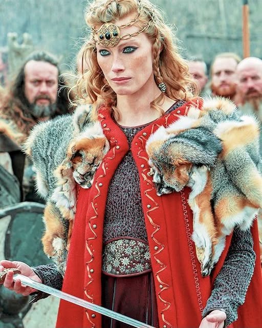 Viking shieldmaiden Aslaug with red braided hair and fur cloak