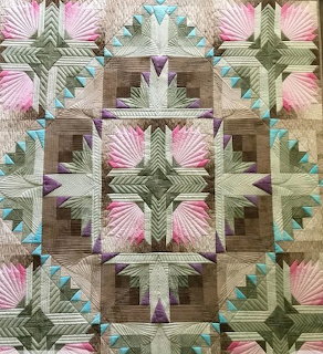 Colorful patchwork quilt with intricate geometric blocks and detailed stitching