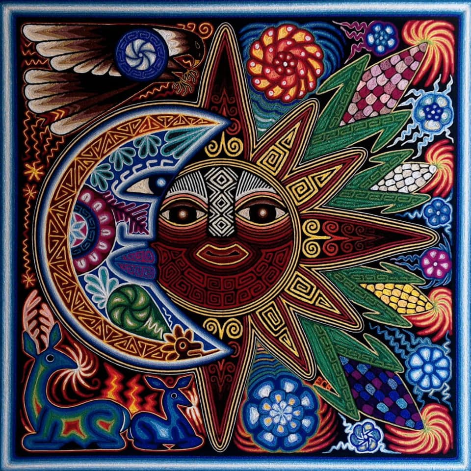 Ornate sun and moon design with colorful geometric patterns and swirls