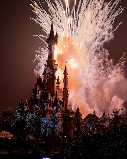 Castle silhouette with bright fireworks exploding in the night sky