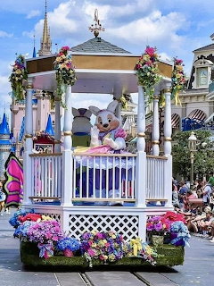 White gazebo float with Disney characters and flower decorations in Easter parade at Magic Kingdom theme park