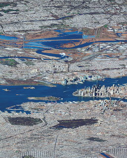 Aerial photograph of New York City with Manhattan skyline, rivers, and surrounding urban landscape