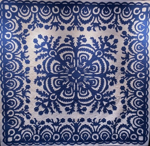 Blue and white patchwork quilt with geometric square pattern