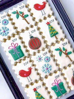 Decorated Christmas cookies with birds, gifts, trees, ornaments, and snowflakes in a grid
