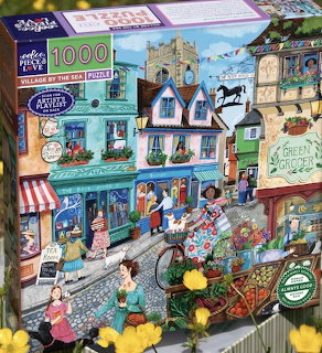 Illustrated coastal village with market, colorful buildings, flowers, and people on cobblestone street